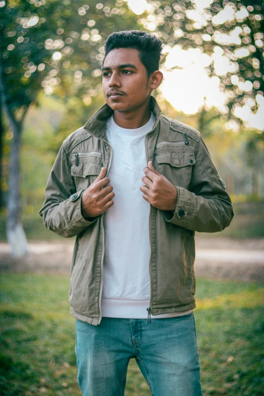 a man wearing an unoned jacket in a wooded area