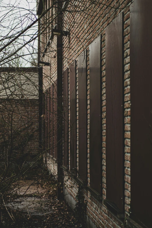 a building with red brick and dark colored windows