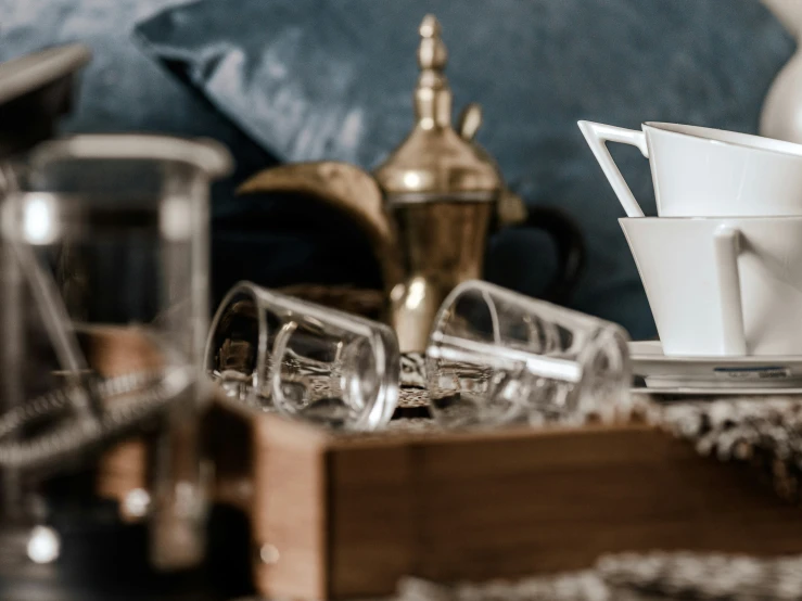 tea set up with wine glasses, pitcher and other items