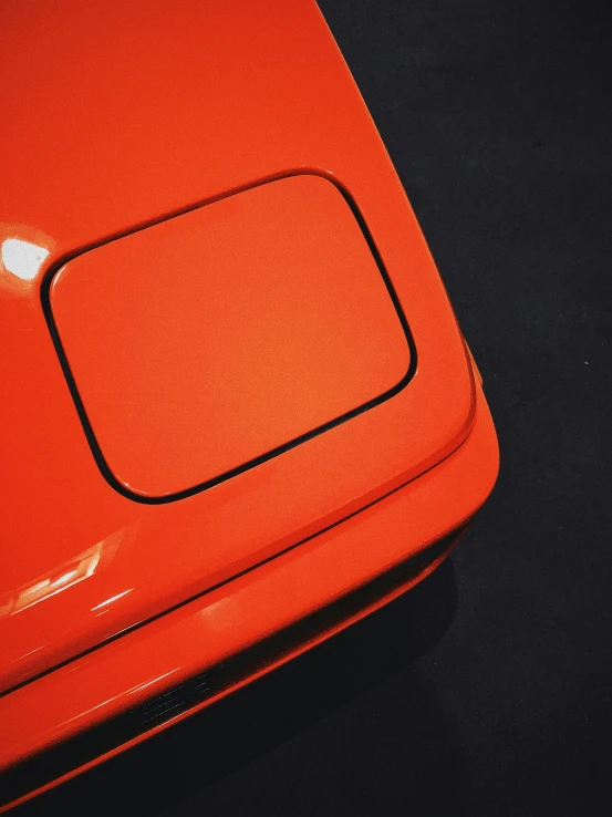 a red piece of luggage sits on the ground