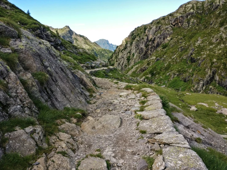 a rocky valley is surrounded by some mountains