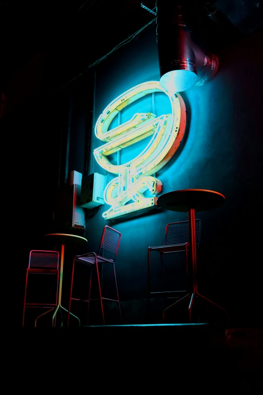 a neon sign is lit up and over an outdoor bar