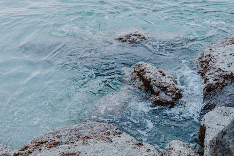 rocks are covered with ice in the water