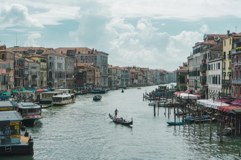 a body of water with many small boats and some buildings