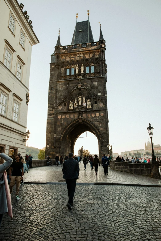 people are walking along a cobblestone street