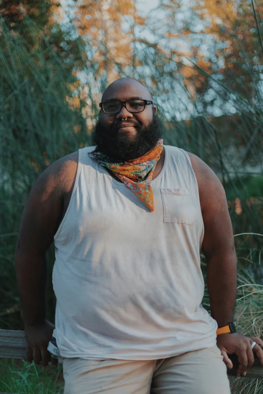 a bearded man with glasses and a tie