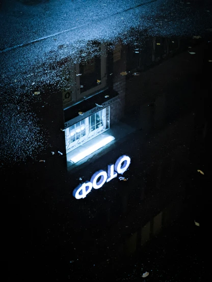 a dark building lit up with a neon sign