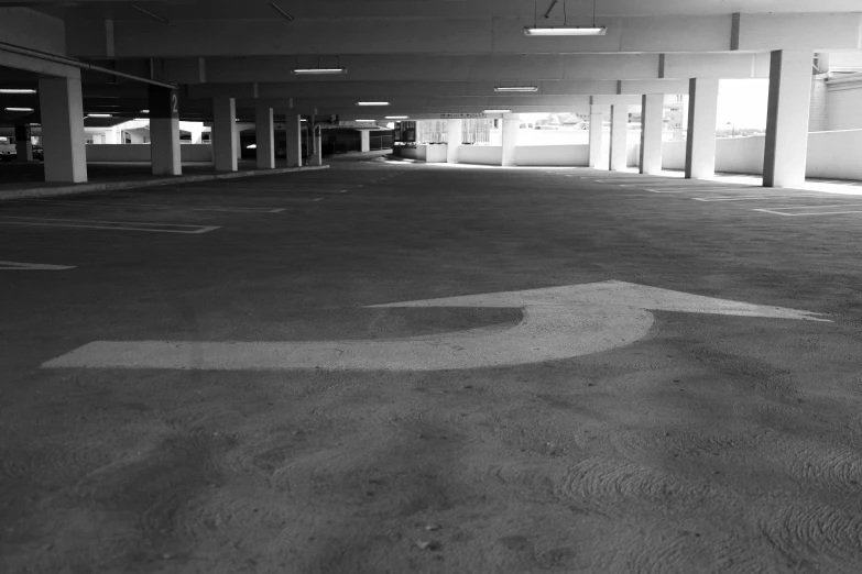 the inside of an empty parking garage with a letter b on the ground