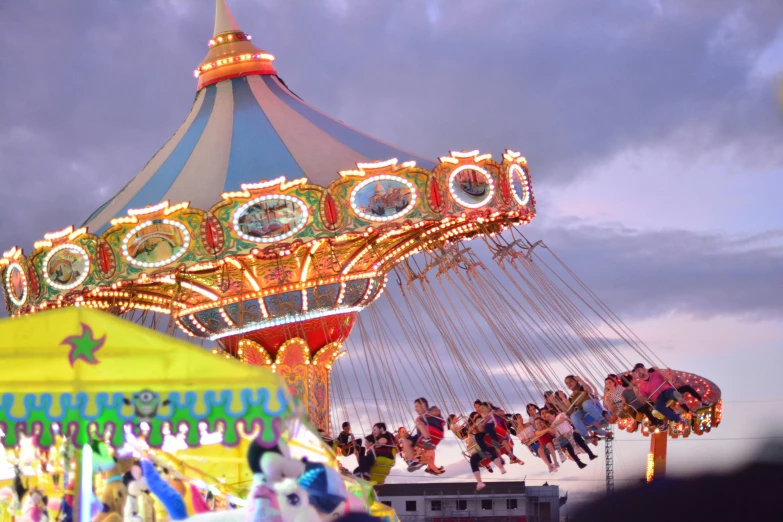 a carnival carousel with people enjoying it