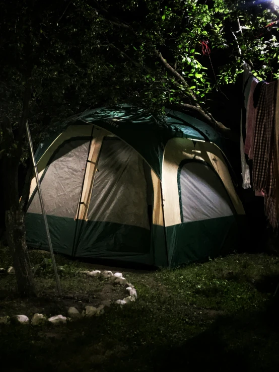 a large tent is up at night and the lights on