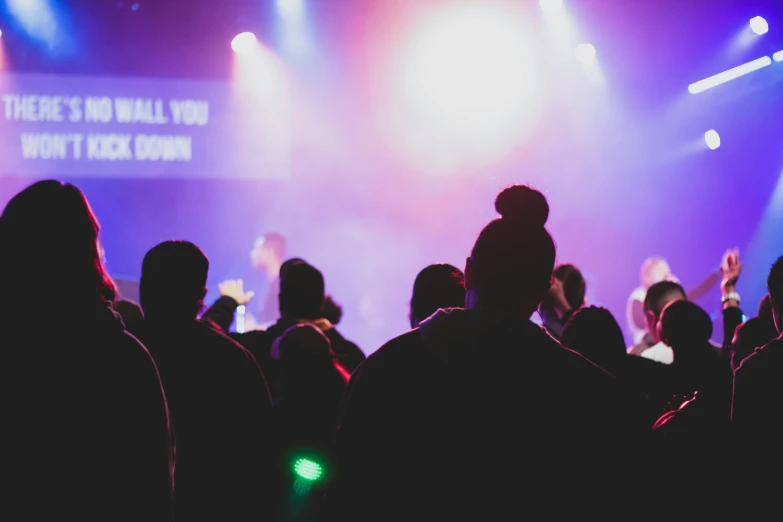 a large group of people on stage with a microphone