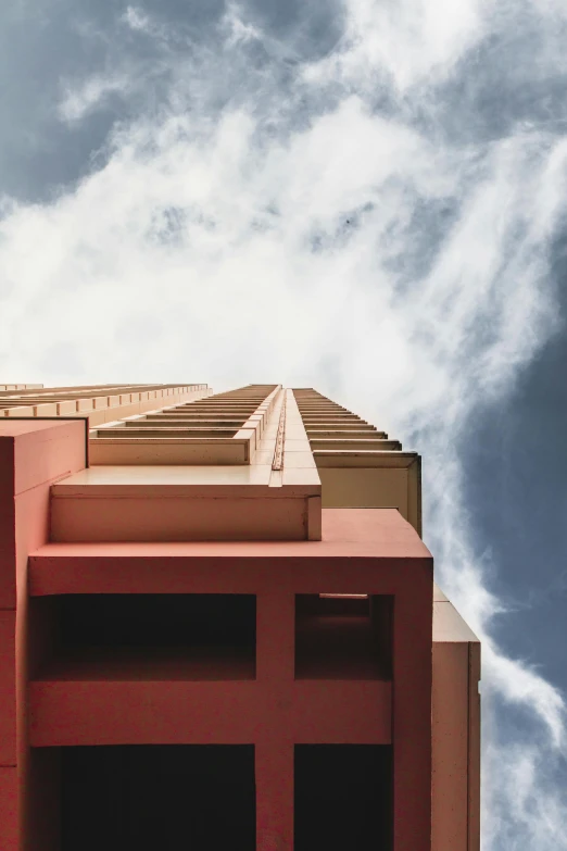 this red building is near many clouds and blue sky