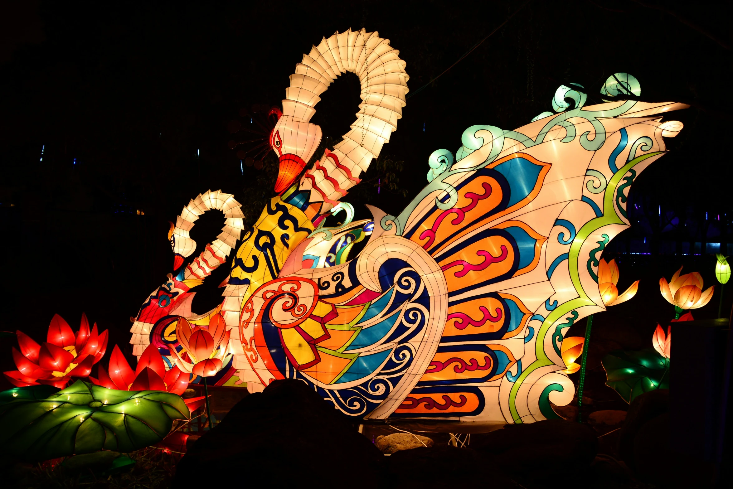 an intricately illuminated dragon at night with bright lights