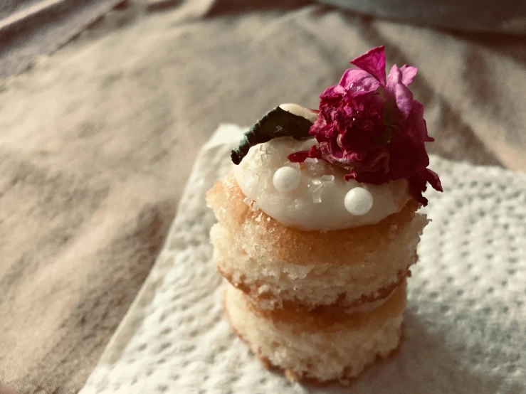 four cakes with decorations on top sitting on a napkin