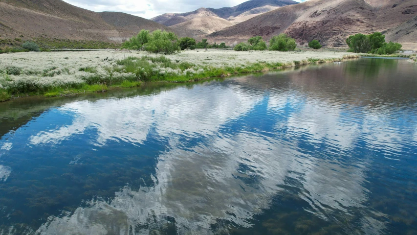 a body of water surrounded by mountains