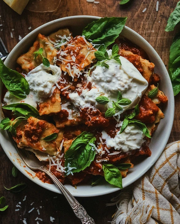 an overhead view of a bowl of pasta and sauce