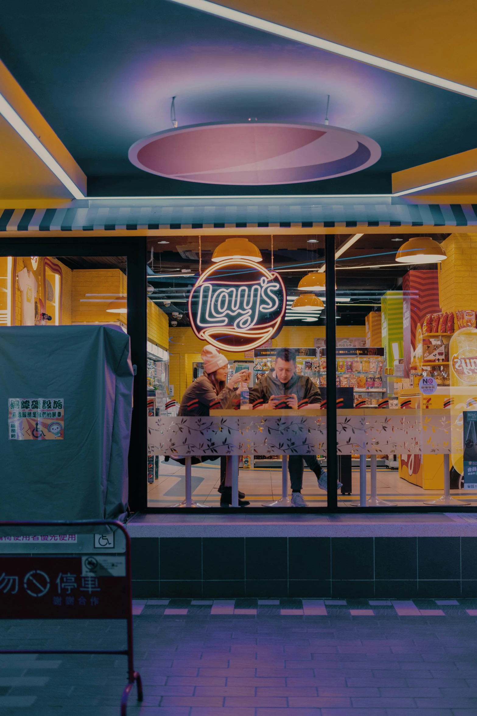 a large food court with a couple customers