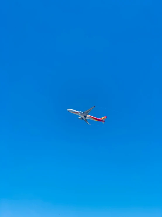 a airplane flying in the sky with an orange tail