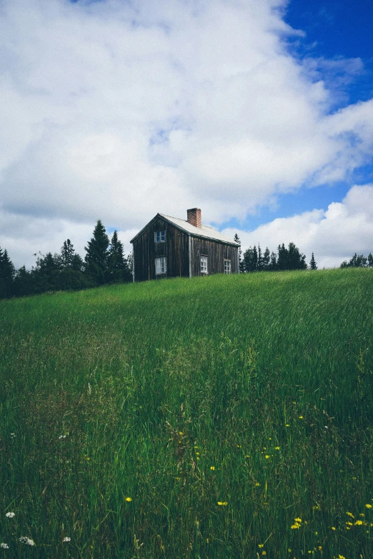 the barn is located on top of the hill