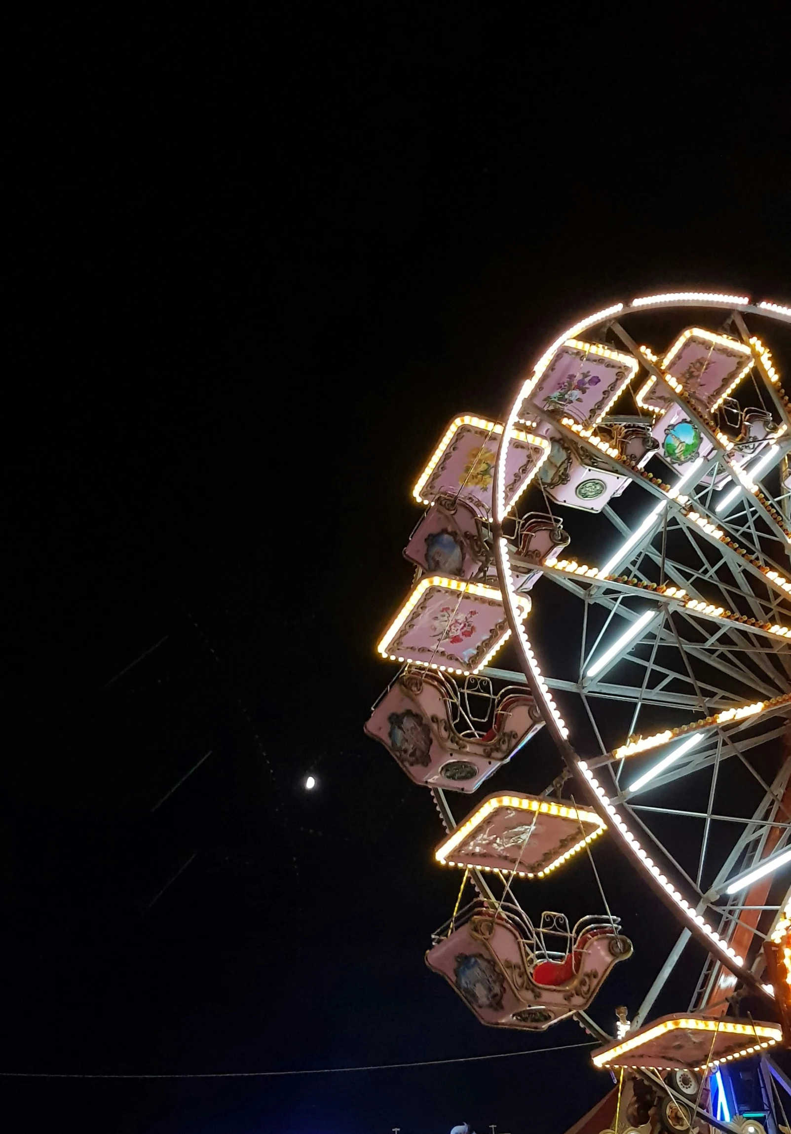 a carousel ride lit up at night with its lights on