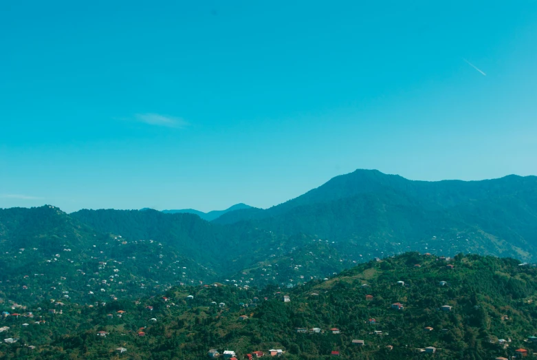 the sky is very blue with green mountains