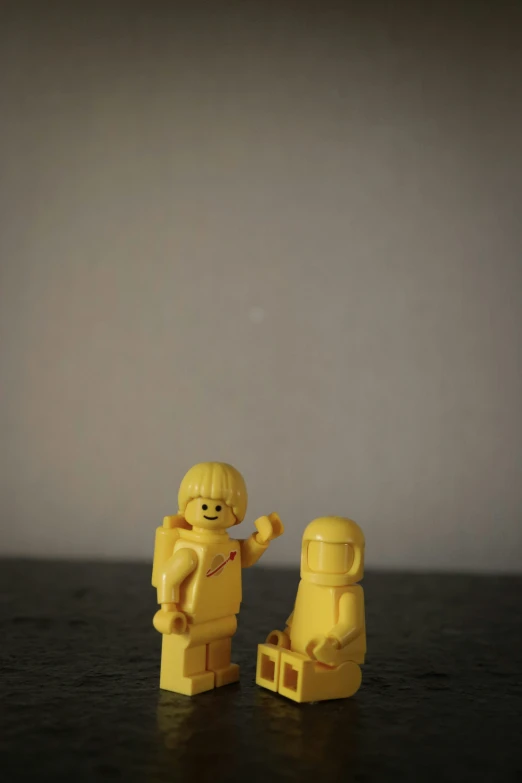 a lego man with his hands in the air