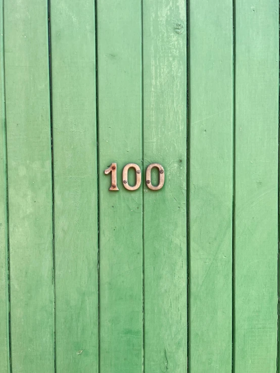the number 100 in pink is seen on a green background