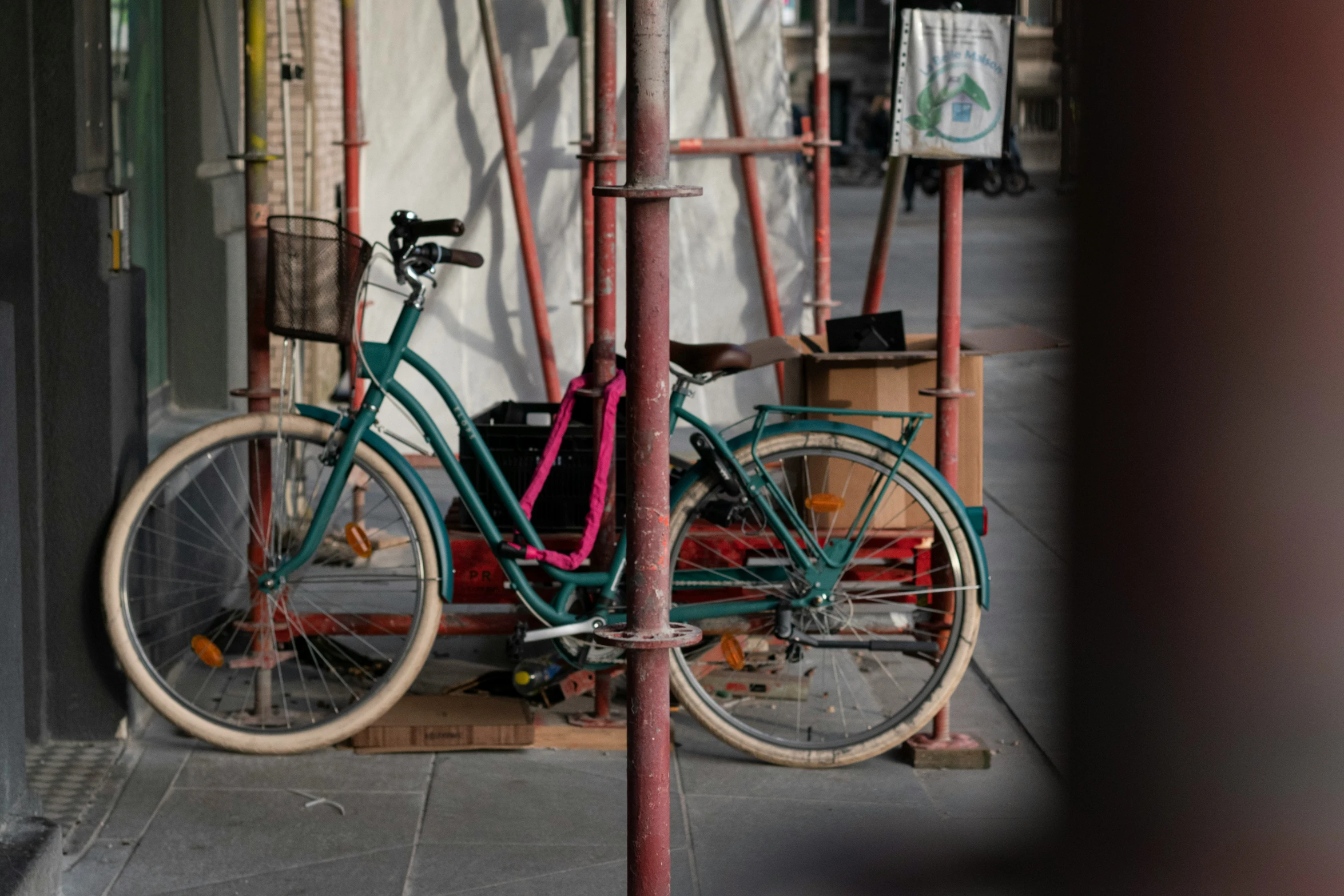 a green bicycle is parked outside of a shop