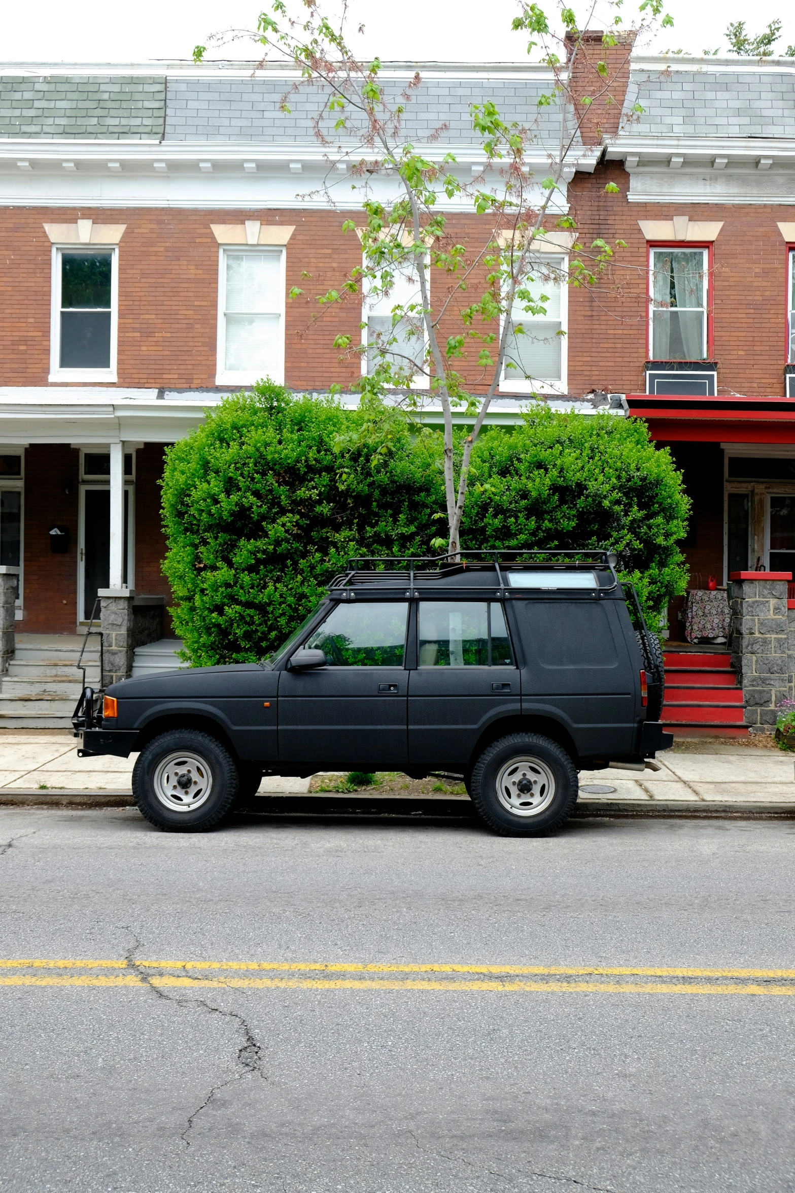 a car parked in front of a two story house