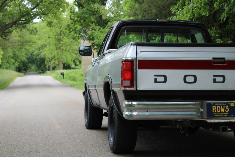 a pick up truck with stripes parked on the side of the road