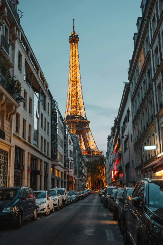 the eiffel tower towering over a city street