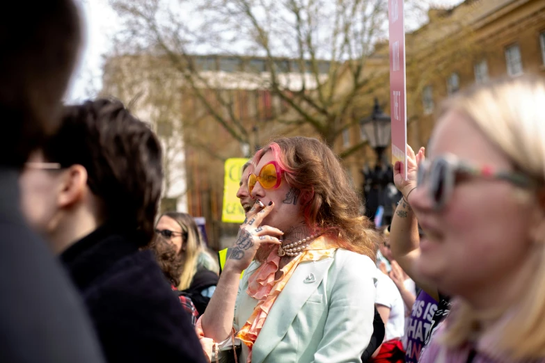 a person with sunglasses on her head standing in a line