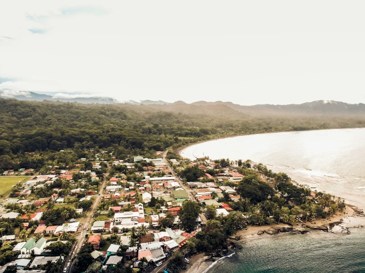 a aerial view of a village near a beach