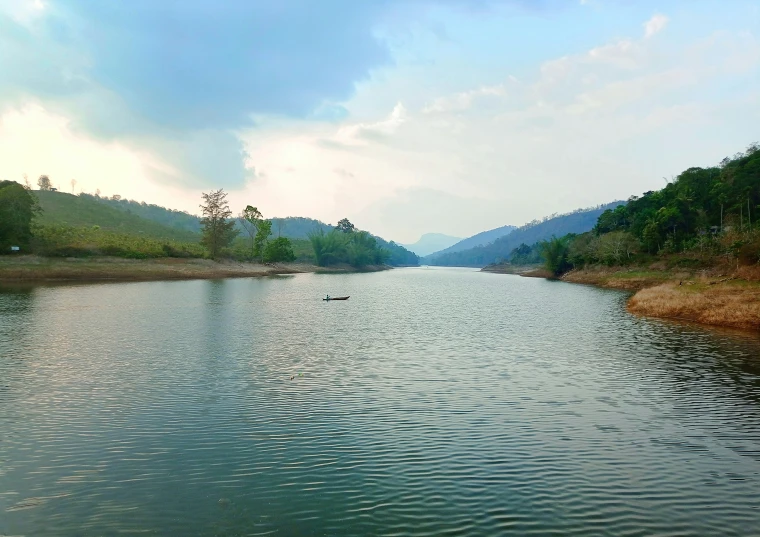 calm water on a lake surrounded by hills