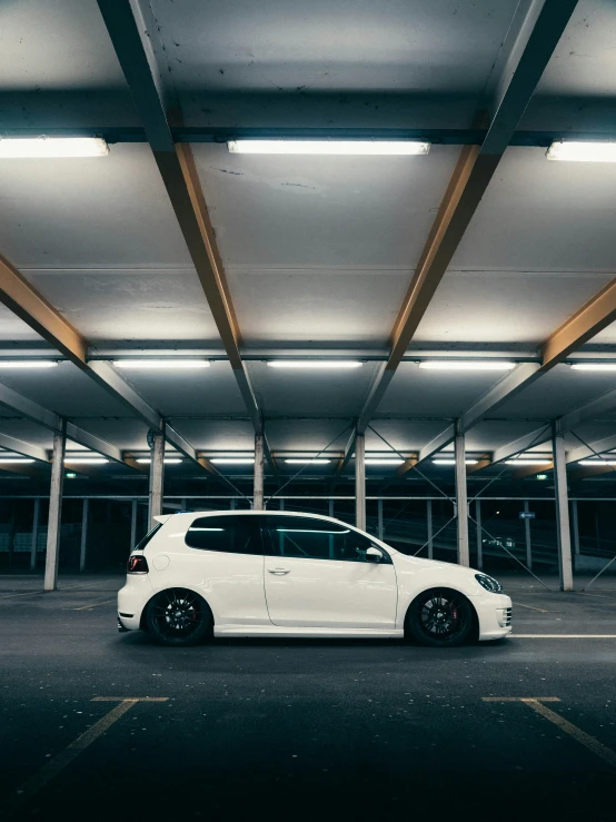 a small white vehicle is parked in the garage