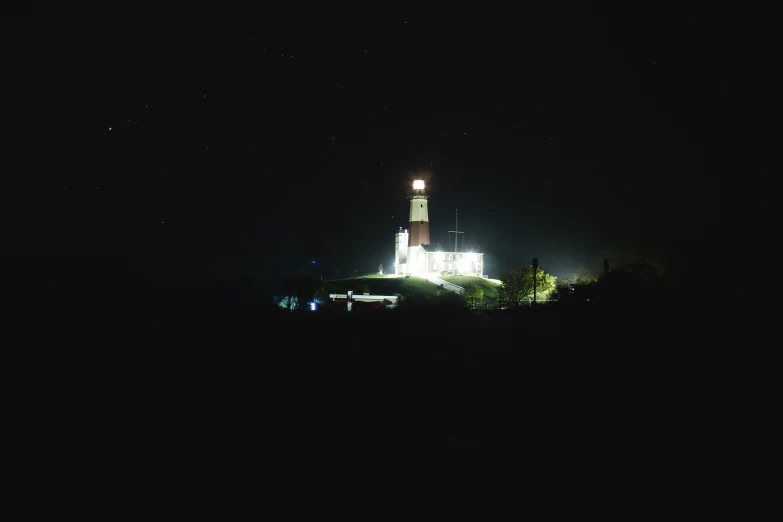 a lighthouse at night that is lit up