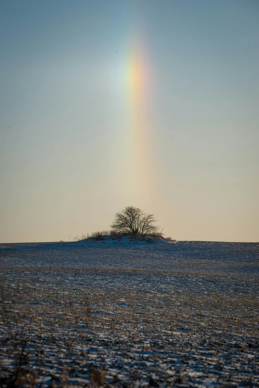 a rainbow that is shining over a small island