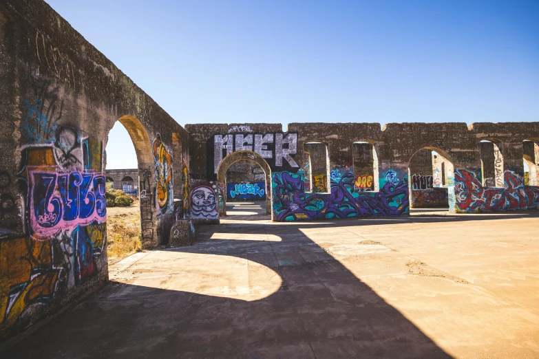 graffiti writing on an abandoned building near a dirt area