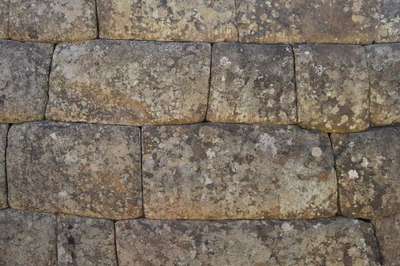 a stone wall made up of brown and gray bricks