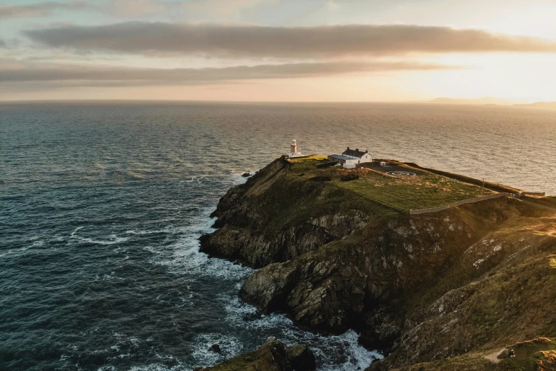 two people are standing on top of an island near the ocean