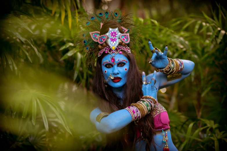 a woman is dressed in blue and has painted face