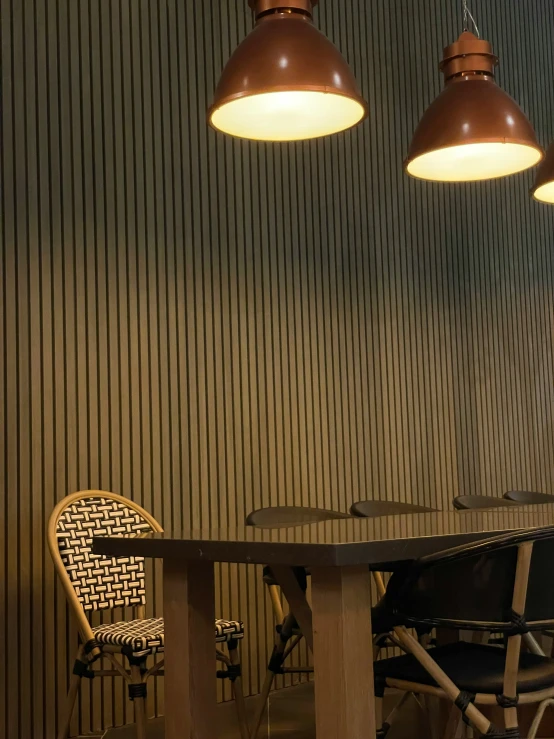 three modern lighting fixtures mounted over a round table