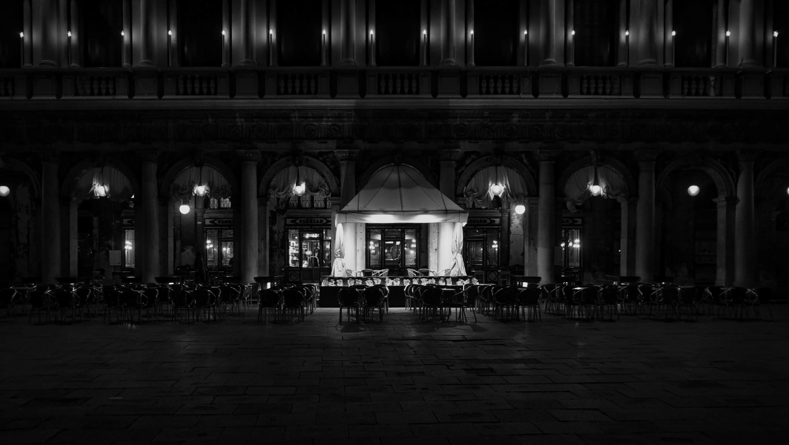 a very dimly lit room with table and chairs