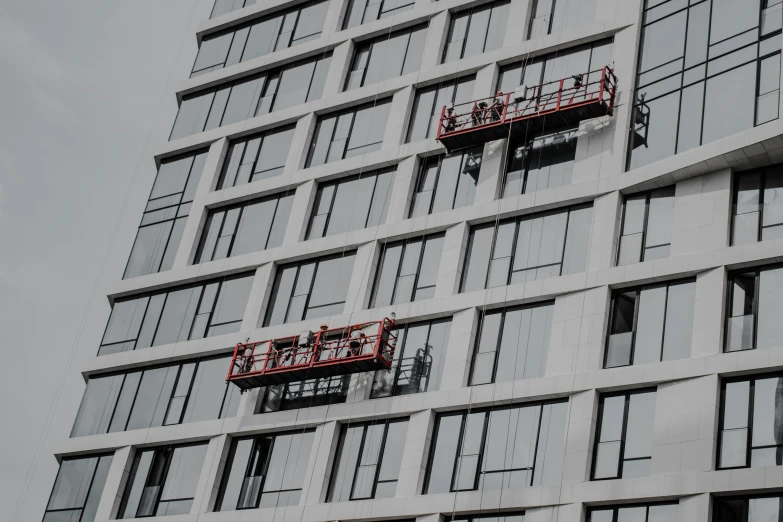 two red signs on the windows of an office building