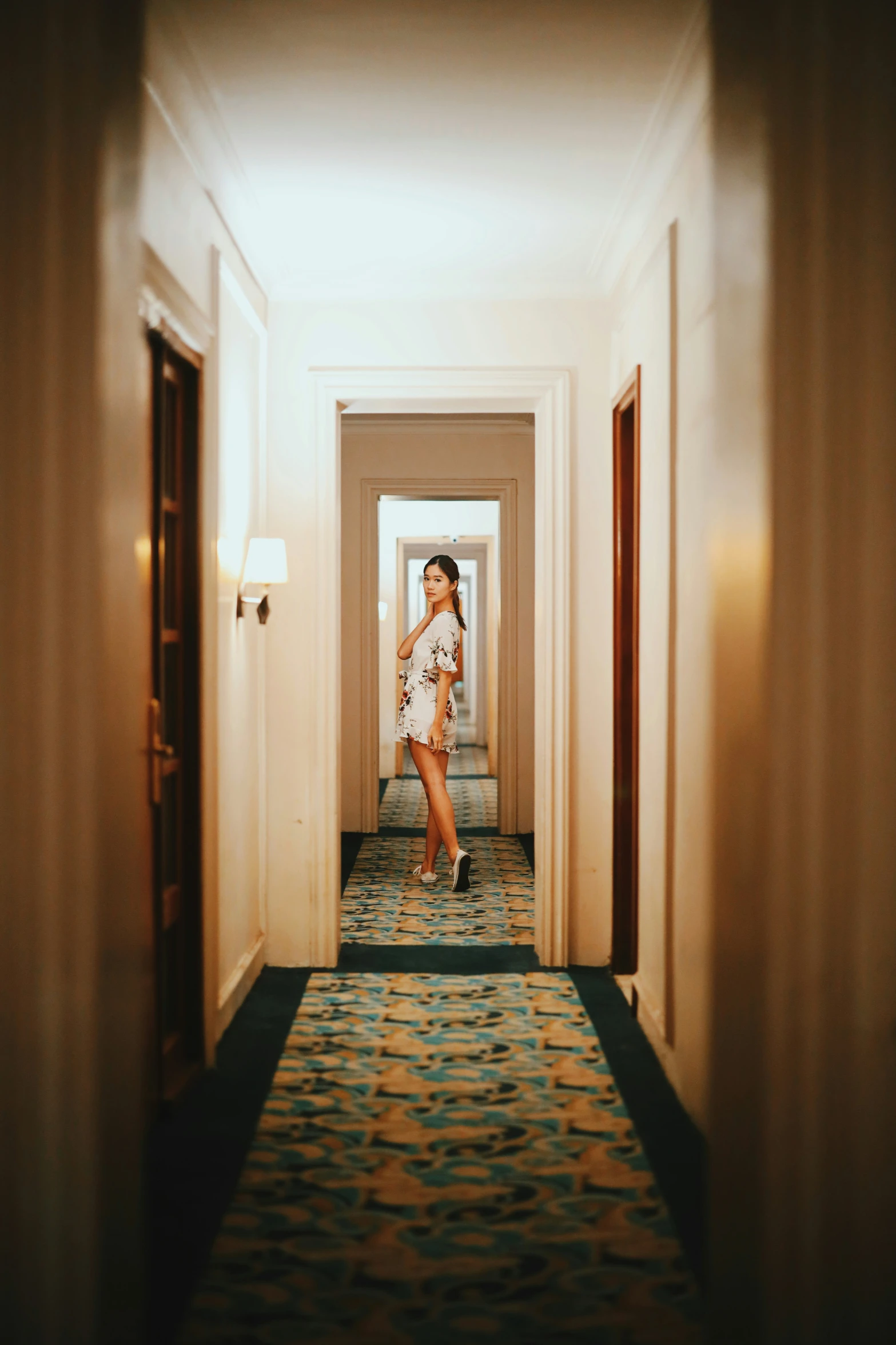 woman wearing a white shirt in an empty el corridor