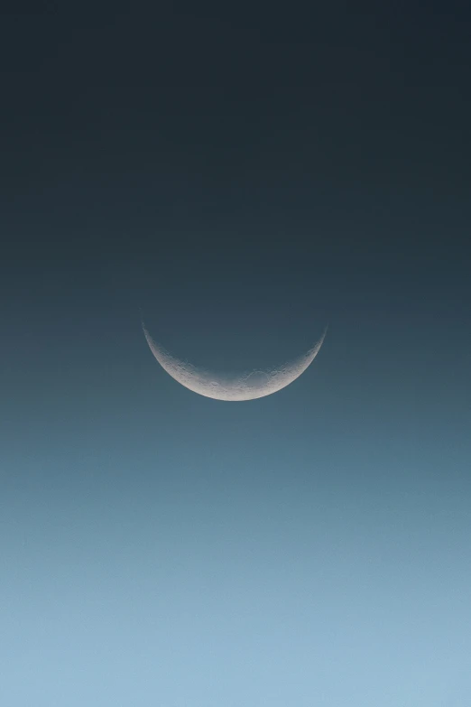 two crescents are shown against a blue sky