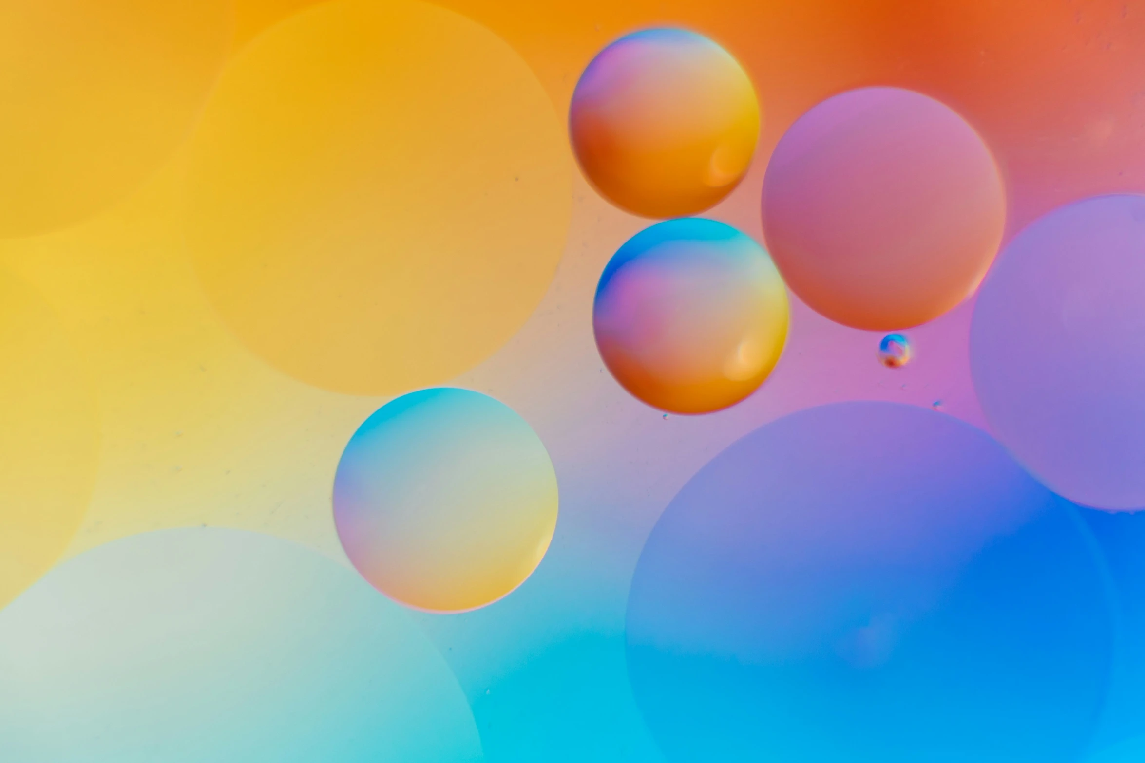 many multicolored bubbles floating on a water surface