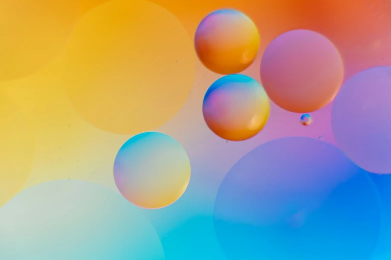 many multicolored bubbles floating on a water surface
