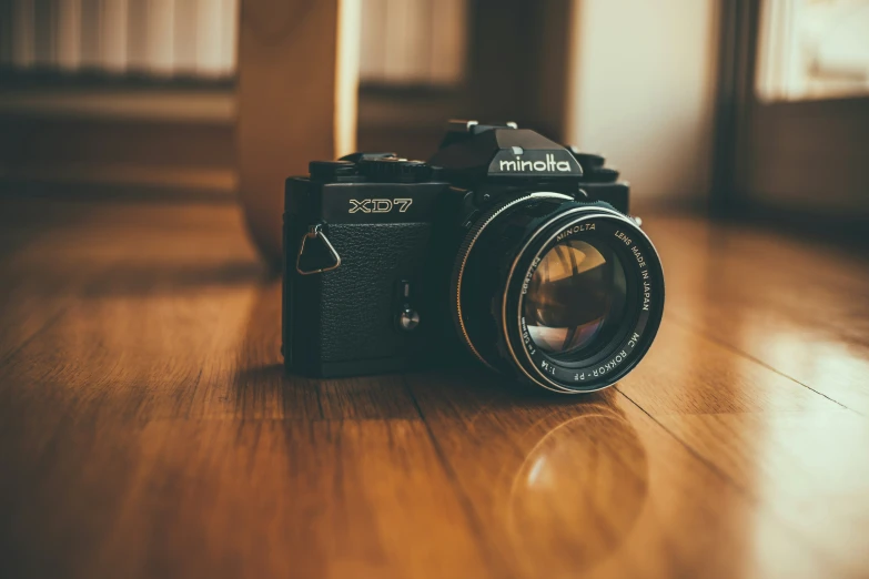 a camera on a wooden floor near a window