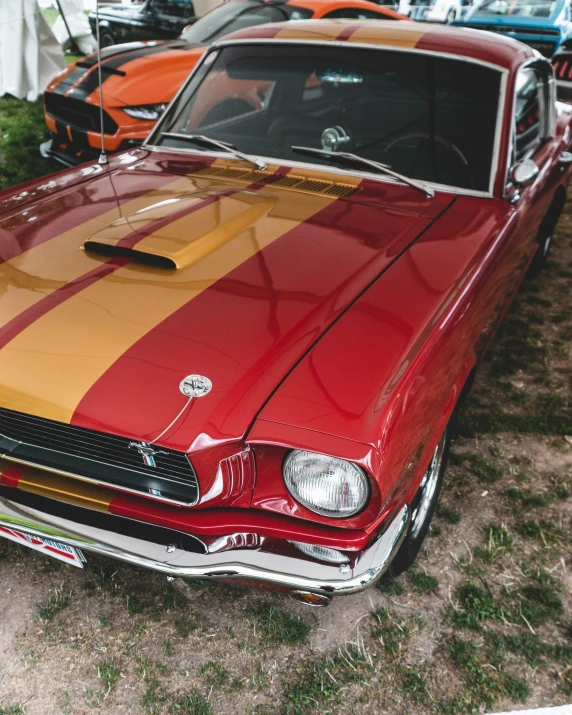 an orange, yellow and red mustang muscle car